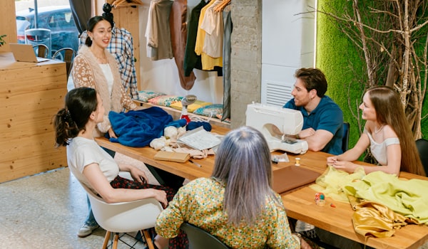 Professional sewing workspace with team working on projects